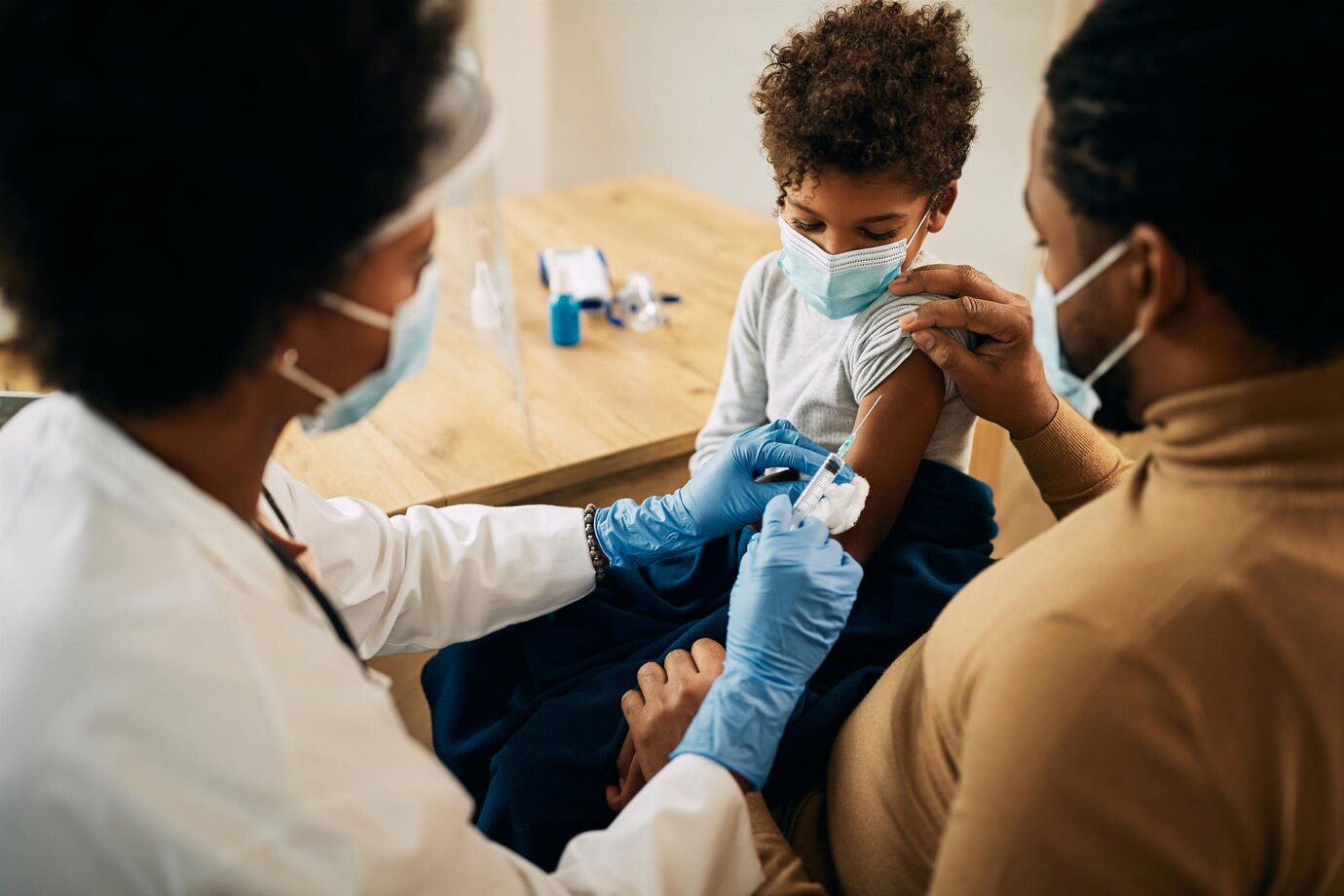 small-black-boy-receiving-vaccine-due-covid19-pandemic_637285-10531